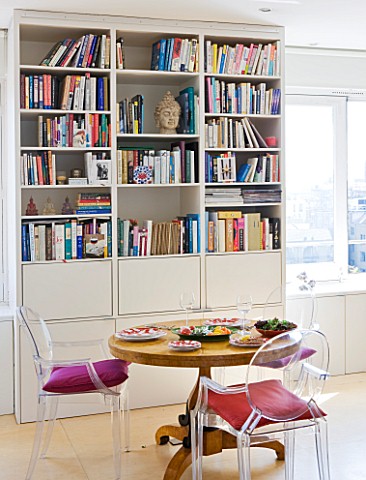 SHELLEY_VON_STRUNCKEL_APARTMENT__LONDON_WOODEN_CIRCULAR_TABLE_AND_PHILIPPE_STARCK_CHAIRS__WITH_BOOKS