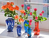 SHELLEY VON STRUNCKEL APARTMENT  LONDON: ROSES IN COLOURED VASES IN THE LIVING AREA