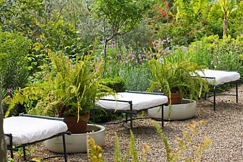 VILLA_FORT_FRANCE__GRASSE__FRANCE_TERRACE_WITH_CHAIRS_AND_CONTAINERS_WITH_FERNS