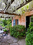 LA CASELLA, FRANCE: TERRACE, PATIO, TABLE, CHAIRS, PERGOLA, WISTERIA, WHITE, COVERED, ENTERTAINING, DINING, MEDITERRANEAN, PROVENCE, FRENCH