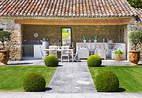 GARDEN_IN_LUBERON__FRANCE__DESIGNED_BY_MICHEL_SEMINI_VIEW_ALONG_PATH_PAST_LAWN_AND_POOL_HOUSE__WASSE