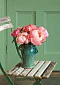 JO BENNISON PEONIES  LINCOLNSHIRE: VASE ON CHAIR WITH PEONY CORAL CHARM