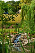 GARDEN IN KENT DESIGNED BY BELLA WHITELEY: VIEW OF WILDFOWER MEADOW AND STREAM FROM LAKE. POOL, WATER, POND, CASCADE, WILDFLOWER MEADOW