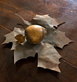 RICHARD CARNILL HOUSE  NOTTINGHAMSHIRE: RUSTY METAL LEAF BOWL FROM THE POTTING SHED  ALDERLY EDGE - WOOD AND METAL FRUIT MADE FROM OLD FRENCH FISHING FLOATS
