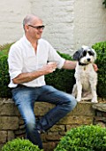 RICHARD CARNILL HOUSE  NOTTINGHAMSHIRE: RICHARD CARNILL  FOUNDER OF CARNILL & COMPANY DECORATIVE INTERIORS AND ANTIQUES  WITH DOG BEARDED COLLIE CROSS CHICO