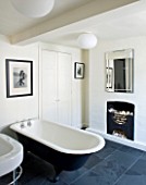 RICHARD CARNILL HOUSE  NOTTINGHAMSHIRE: BATHROOM WITH CAST IRON BATH  SLATE FLOOR  RADIATOR BY BISQUE. MIRROR JOHN LEWIS. WALLS PAINTED IN FARROW AND BALL POINTING