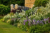 BROUGHTON CASTLE, OXFORDSHIRE: HERBACEOUS BORDER ALONG THE GARDEN WALL WITH THE GATEHOUSE BEHIND - FLOWERS, SUMMER, FLOWERING, ENGLISH GARDEN, COUNTRY GARDEN