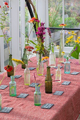 HELMSLEY_WALLED_GARDEN__YORKSHIRE_FLOWERS_PICKED_FROM_THE_GARDEN_PLACED_IN_BOTTLES_ON_TABLE_IN_GREEN