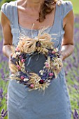 YORKSHIRE LAVENDER  YORKSHIRE:GIRL HOLDING DECORATIVE LAVENDER WREATHS MADE FROM DRIED LAVENDER