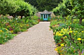 SLEDMERE HOUSE GARDEN, YORKSHIRE: EXOTIC BORDERS WITH ANNUALS AND TENDER AND HARDY PERENNIALS - SHED / SUMMERHOUSE AT END OF GRAVEL PATH - ANNUALS, COUNTRY GARDEN, FOCAL POINT