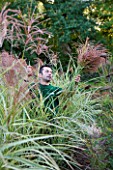CHATEAU DE CHENONCEAU  FRANCE: FLORIST DAVID HOGUET PICKS MISCANTHUS FOR A FLOWER DISPLAY IN THE CHATEAU IN THE POTAGER/ CUTTING GARDEN  MORNING LIGHT