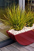 ROOF GARDEN IN SHOREDITCH  LONDON  DESIGNED BY AMIR SCHLEZINGER OF MY LANDSCAPES: RED CONTAINER ON DECKED ROOF WITH LIBERTIA GOLDFINGER