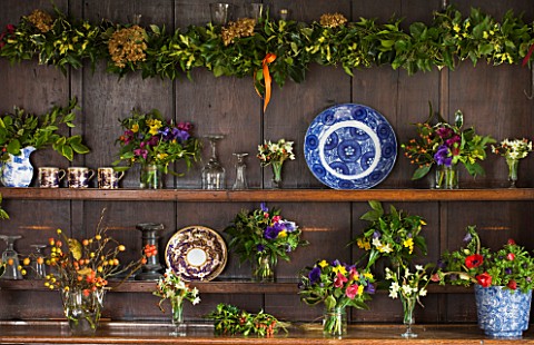 COMMON_FARM_FLOWERS_SOMERSET_DRESSER_IN_COMMON_FARM_FLOWER_ROOM_BERRIED_HOLLY__ROSEHIPS__SCILLY_ISLE