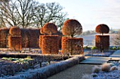 BROUGHTON GRANGE, OXFORDSHIRE: DESIGNER TOM STUART - SMITH: CLIPPED TOPIARY BEECH HEDGES IN FROST IN THE WALLED GARDEN. WINTER, COUNTRY GARDEN, TRIMMED, EVERGREEN