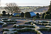 BROUGHTON GRANGE, OXFORDSHIRE: DESIGNER TOM STUART - SMITH: CLIPPED TOPIARY BOX HEDGES. PARTERRE. WINTER, COUNTRY GARDEN, TRIMMED, HEDGING, MOUND