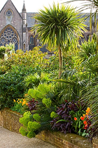 ARUNDEL_CASTLE_GARDENS__WEST_SUSSEX_THE_COLLECTOR_EARLS_GARDEN_RAISED_BED_WITH_EUPHORBIAS_AND_TULIPS