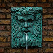 WATER FEATURE: CLASSICAL HEAD OF NEPTUNE WATER SPOUT  PAINTED VERDIGRIS. DESIGNER: ANTHONY NOEL