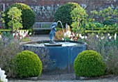 ARUNDEL CASTLE GARDENS  WEST SUSSEX: THE VEGETABLE GARDEN WITH LEAD FOUNTAIN WITH CHERUB SURROUNDED BY BOX BALLS AND TULIPS