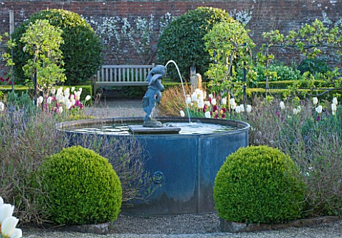 ARUNDEL_CASTLE_GARDENS__WEST_SUSSEX_THE_VEGETABLE_GARDEN_WITH_LEAD_FOUNTAIN_WITH_CHERUB_SURROUNDED_B