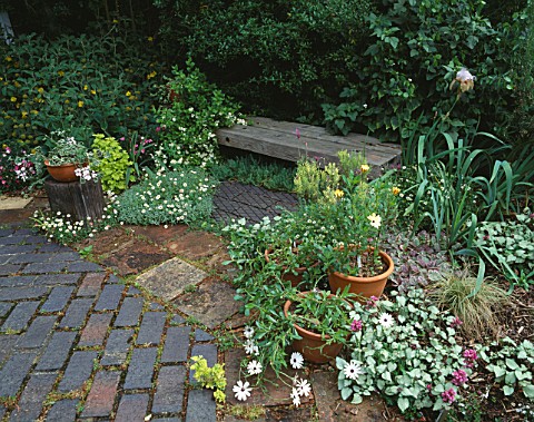 WOODEN_SEAT_MADE_OF_RAILWAY_SLEEPERS_SURROUNDED_BY_POTS_ON_OCTAGON_TERRACE__TURN_END__BUCKS