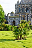 ARUNDEL CASTLE GARDENS, WEST SUSSEX: THE COLLECTOR EARLS GARDEN: TRACHYCARPUS FORTUNEI ON THE LAWN - DESIGNED BY JULIAN AND ISABEL BANNERMAN