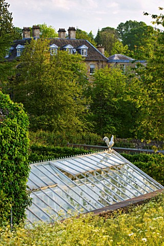 ROCKCLIFFE_HOUSE__GLOUCESTERSHIRE_VIEW_OF_HOUSE_WITH_GREENHOUSE_IN_THE_FOREGROUND