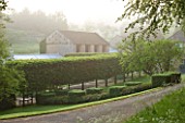 ROCKCLIFFE HOUSE, GLOUCESTERSHIRE: FRONTDRIVE IN MIST AND FOG WITH GREEN HEDGING