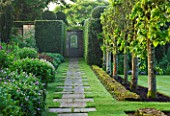 ROCKCLIFFE HOUSE, GLOUCESTERSHIRE: PATH TO DOOR WITH YEW HEDGES, BORDER AND TOPIARY STILT HEDGING BESIDE LAWN - GREEN, COUNTRY GARDEN, SUMMER