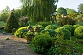 ROCKCLIFFE HOUSE, GLOUCESTERSHIRE: TERRACE WITH LAWN AND CLIPPED TOPIARY BALLS AND PYRAMID OF CLIPPED TOPIARY BEECH, SUMMER, GREEN