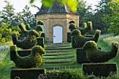 ROCKCLIFFE HOUSE, GLOUCESTERSHIRE: ROW OF CLIPPED TOPIARY BIRDS LEADING UP TO DOVECOTE. SUMMER, COUNTRY GARDEN, EVERGREEN, SHRUBS, SHAPED, TRIMMED