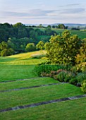BROCKHAMPTON COTTAGE, HEREFORDSHIRE: LAWN AND TERRACING WITH BORDER AND VIEW TO COUNTRYSIDE BEYOND - COUNTRY GARDEN, INFORMAL, JUNE, SUMMER, GREEN