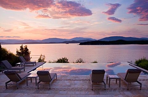 CORFU_GREECE__THE_KASSIOPIA_ESTATE_EVENING_LIGHT__DUSK_ON_THE_TERRACE_LOOKING_OUT_TO_SEA_WITH_SUN_LO
