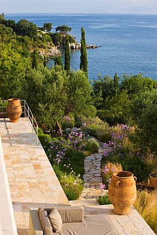 CORFU_GREECE__THE_KASSIOPIA_ESTATE_VIEW_LOOKING_DOWN_ONTO_THE_GARDEN_AND_OUT_TO_SEA_WITH_STONE_PATH_