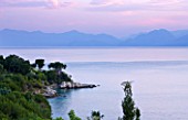 CORFU, GREECE - THE KASSIOPIA ESTATE. VIEW OUT TO SEA WITH ALBANIAN MOUNTAINS IN THE DISTANCE