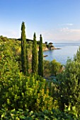 CORFU, GREECE - THE KASSIOPIA ESTATE. VIEW FROM THE VILLA LOOKING OUT TO SEA WITH CYPRESS TREES