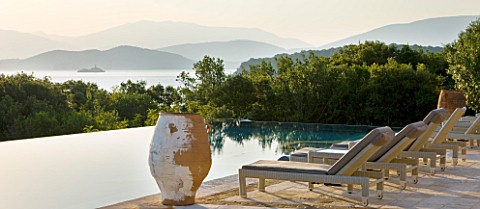CORFU_GREECE__THE_KASSIOPIA_ESTATE_THE_TERRACE_AND_SWIMMING_POOL_WITH_SUN_LOUNGERS_AND_TERRACOTTA_UR