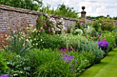 BIRTSMORTON COURT, WORCESTERSHIRE: THE WALLED GARDEN - BORDER WITH PEONIES, TRADESCANTIA, CLEMATIS, ROSES, GERANIUMS, SUMMER, JUNE, WALL, WALLS, HERBACEOUS