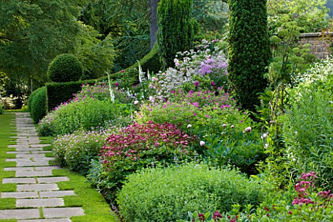 ROCKCLIFFE_HOUSE_GLOUCESTERSHIRE_HERBACEOUS_BORDER_BESIDE_PATH_WITH_ASTRANTIAS_ROSES_PEONIES_YEW_GER