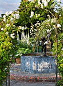 BIRTSMORTON COURT, WORCESTERSHIRE: WHITE GARDEN - LEAD POOL / POND WITH CHERUB FOUNTAIN, WHITE DELPHINIUMS AND METAL ARCH WITH ROSE SNOWDRIFT. COUNTRY GARDEN, CLASSIC, ENGLISH