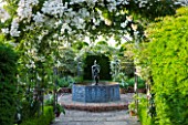 BIRTSMORTON COURT, WORCESTERSHIRE: WHITE GARDEN - LEAD POOL / POND WITH CHERUB FOUNTAIN, WHITE DELPHINIUMS AND METAL ARCH WITH ROSE WICKWAR. COUNTRY GARDEN, CLASSIC, ENGLISH