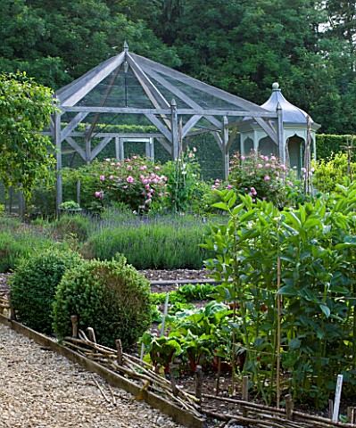 POULTON_HOUSE_GARDEN_WILTSHIRE_THE_KITCHEN_GARDEN_WITH_FRUIT_CAGE_ROSES_AND_VEGETABLE_BORDERS_POTAGE
