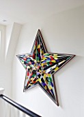 BEN DE LISI HOUSE AND GARDEN  LONDON: DECORATIVE STAR SCULPTURE ON WALL BY STAIRCASE