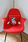 BEN DE LISI HOUSE AND GARDEN  LONDON: RED CHAIR IN LIVING ROOM WITH BEN DE LISI DOG CUSHION