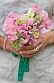 COMMON FARM FLOWERS, SOMERSET, SUMMER: LADY HOLDING BOUQUET OF SWEET PEAS IN THE GARDEN - FLOWER, FLOWERS, POSIE, HANDS