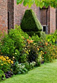 CHENIES MANOR, BUCKINGHAMSHIRE: BORDER BESIDE THE MANOR HOUSE WITH LAWN, DAHLIAS, HELENIUMS, RUDBECKIAS, CROCOSMIA AND TRADESCANTIA - HERBACEOUS, LATE SUMMER, COUNTRY, CLASSIC