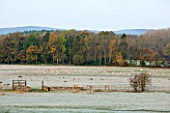 HOLKER HALL  CUMBRIA: VIEW ALONG FROSTY FIELD IN AUTUMN TO THE DEER PARK  ROCK WITH LAKE DISTRICT BEYOND