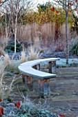 ELLICAR GARDENS, NOTTINGHAMSHIRE: PAVED PATIO AREA BESIDE POOL WITH CURVED WOODEN BENCH/ SEAT