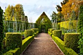 EAST RUSTON OLD VICARAGE GARDEN, NORFOLK: THE LONG BORDERS WITH GRAVEL PATH, CLIPPED TOPIARY BOX HEDGING AND HORNBEAM TOPIARY HOUSE - SPRING, VIEW, VISTA, TRIMMED, HEDGE