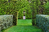 EAST RUSTON OLD VICARAGE GARDEN, NORFOLK: HEDGES AND VIEWS THROUGH TO STONE SEAT IN SPRING. GREEN, HEDGING, CLIPPED, TOPIARY, TRIMMED