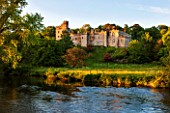 HADDON HALL, DERBYSHIRE: THE HALL WITH THE RIVER WYE IN FRONT OF IT - EVENING LIGHT, JUNE